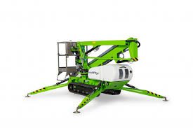 A green and white cherry picker is on the ground
