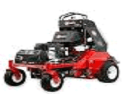 A red and black lawn mower with a large stack of luggage.