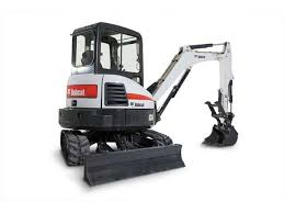 A small white and black excavator with a shovel.