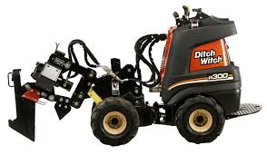 A black and orange tractor with a plow attachment.