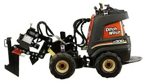 A black and orange tractor with a plow attachment.