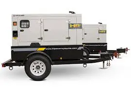 A trailer mounted generator is parked on the side of the road.