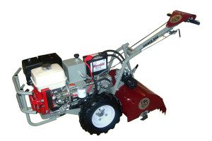 A red and white tractor with a plow attachment.