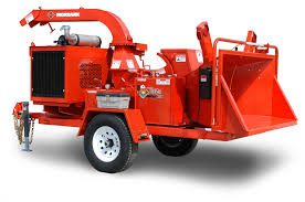 A red trailer with a wood chipper on it